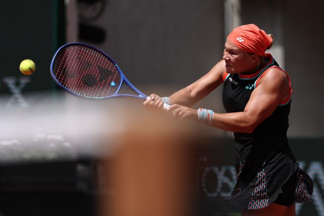 Diana Shnaider plays a backhand return to US Madison Keys during their women's singles match on day 9 of the French Open tennis tournament on Court Suzanne-Lenglen at the Roland-Garros Complex in Paris on June 1, 2026. (Photo by Anne-Christine POUJOULAT / AFP)