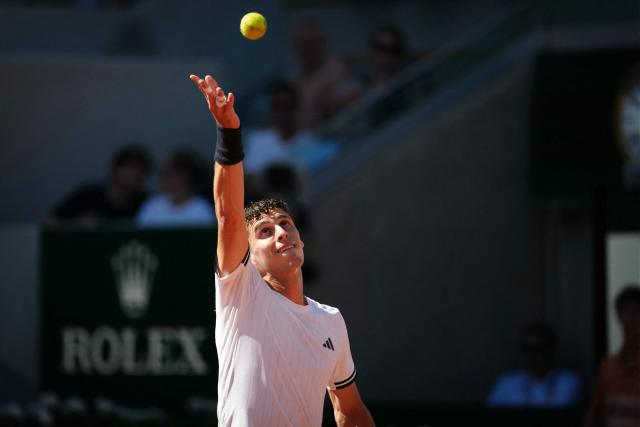 Argentina's Juan Manuel Cerundolo serves to Italy's Matteo Berrettini during their men's singles match on day 9 of the French Open tennis tournament on Court Suzanne-Lenglen at the Roland-Garros Complex in Paris on June 1, 2026. (Photo by Dimitar DILKOFF / AFP)