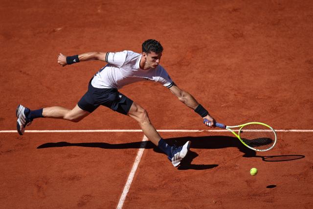 Argentina's Juan Manuel Cerundolo plays a forehand return to Italy's Matteo Berrettini during their men's singles match on day 9 of the French Open tennis tournament on Court Suzanne-Lenglen at the Roland-Garros Complex in Paris on June 1, 2026. (Photo by Anne-Christine POUJOULAT / AFP)