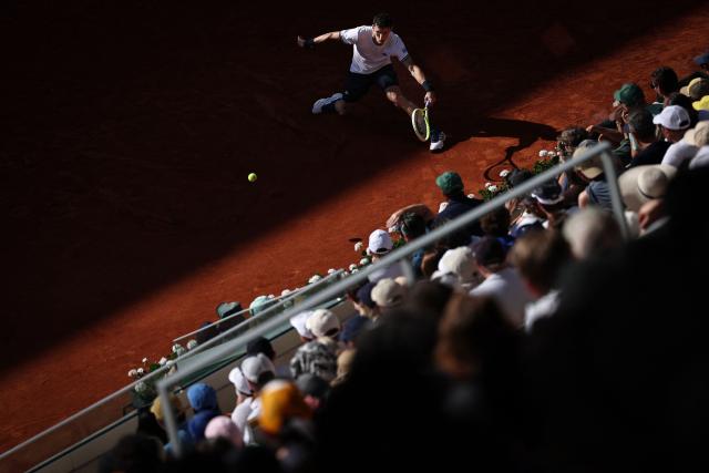 Argentina's Juan Manuel Cerundolo plays a forehand return to Italy's Matteo Berrettini during their men's singles match on day 9 of the French Open tennis tournament on Court Suzanne-Lenglen at the Roland-Garros Complex in Paris on June 1, 2026. (Photo by Anne-Christine POUJOULAT / AFP)