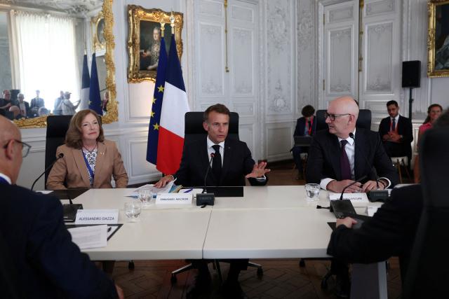 France's President Emmanuel Macron (C), CEO of USA Rare Earth Barbara Humpton (L) and France's Economy, Finances and Industry Minister Roland Lescure (R) attend a meeting of the metals and energy transition sector during the "Choose France" business summit, aiming to attract foreign investors to the country, at the Chateau de Versailles in Versailles, near Paris on June 1, 2026. (Photo by Gonzalo Fuentes / POOL / AFP)