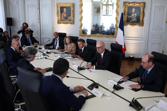 (From top L) CEO of Siemens Gamesa Vinod Philip, CEO of USA Rare Earth Barbara Humpton, France's President Emmanuel Macron, France's Economy, Finances and Industry Minister Roland Lescure, CEO of the Caisse de dépôt et placement du Québec Charles Emond and CEO of Envision Group Lei Zhang (bottom row R) attend a meeting of the metals and energy transition sector during the "Choose France" business summit, aiming to attract foreign investors to the country, at the Chateau de Versailles in Versailles, near Paris on June 1, 2026. (Photo by Gonzalo Fuentes / POOL / AFP)
