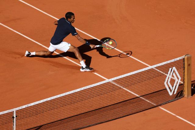 Canada's Felix Auger-Aliassime plays a backhand return to Chile's Alejandro Tabilo during their men's singles match on day 9 of the French Open tennis tournament on Court Philippe-Chatrier at the Roland-Garros Complex in Paris on June 1, 2026. (Photo by ALAIN JOCARD / AFP)
