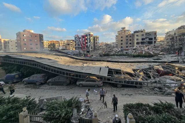People gather at the site of an Israeli strike that hit near a hospital in the southern Lebanese city of Tyre on June 1, 2026. Lebanon said an Israeli strike hit near a hospital in the southern city of Tyre on June 1 as the health ministry shared footage showing heavy damage to the facility. The state-run National News Agency said a strike targeting an intersection near the Jabal Amel hospital "hit a building and the parking lot, resulting in a number of wounded". (Photo by KAWNAT HAJU / AFP)
