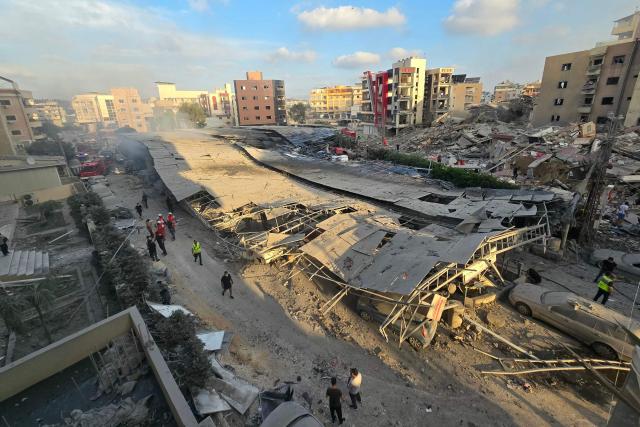 First responders gather at the site of an Israeli strike that hit near a hospital in the southern Lebanese city of Tyre on June 1, 2026. Lebanon said an Israeli strike hit near a hospital in the southern city of Tyre on June 1 as the health ministry shared footage showing heavy damage to the facility. The state-run National News Agency said a strike targeting an intersection near the Jabal Amel hospital "hit a building and the parking lot, resulting in a number of wounded". (Photo by KAWNAT HAJU / AFP)