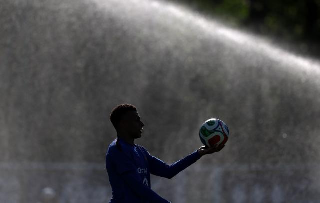 France's forward #10 Kylian Mbappe holds the ball during a training session at the national team training grounds in Clairefontaine-en-Yvelines, southwest of Paris, on June 1, 2026, as part of their preparation for the upcoming 2026 FIFA World Cup football tournament. (Photo by FRANCK FIFE / AFP)