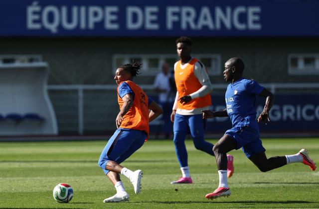 France's forward #11 Michael Olise (L) fights for the ball with France's midfielder #13 N'Golo Kante (R) during a training session at the national team training grounds in Clairefontaine-en-Yvelines, southwest of Paris, on June 1, 2026, as part of their preparation for the upcoming 2026 FIFA World Cup football tournament. (Photo by FRANCK FIFE / AFP)
