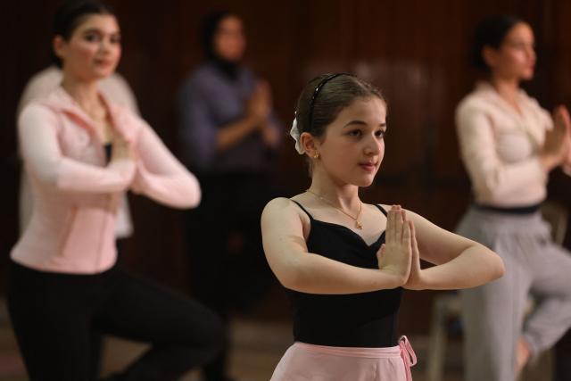 Iraqi girls practise yoga at a dance and ballet school in the Mansour district of Baghdad on June 1, 2026, preparation for International Day of Yoga. (Photo by AHMAD AL-RUBAYE / AFP)