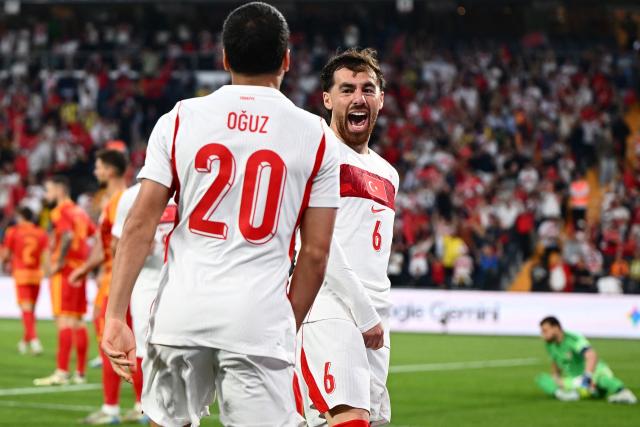 Turkey's midfielder #6 Orkun Kokcu (R) celebrates with Turkey's forward #20 Oguz Aydin (L) after scoring his team's first goal during the international friendly football match between Turkey and North Macedonia at the Chobani stadium in Istanbul on June 1, 2026, ahead of the 2026 FIFA World Cup. (Photo by Yasin AKGUL / AFP)