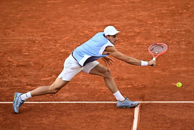 US Frances Tiafoe plays a backhand return to Italy's Matteo Arnaldi during their men's singles match on day 9 of the French Open tennis tournament on Court Suzanne-Lenglen at the Roland-Garros Complex in Paris on June 1, 2026. (Photo by JULIEN DE ROSA / AFP)