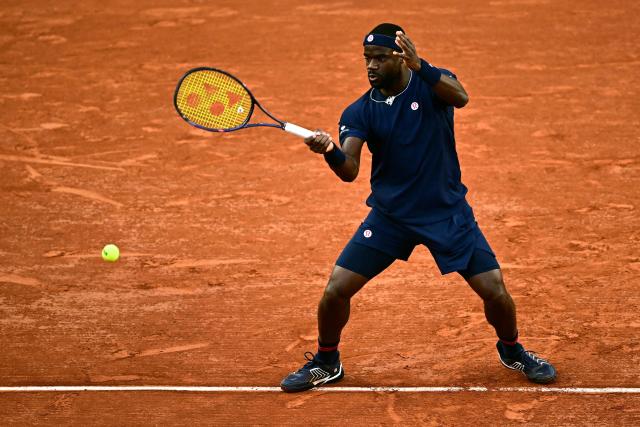 US Frances Tiafoe plays a forehand return to Italy's Matteo Arnaldi during their men's singles match on day 9 of the French Open tennis tournament on Court Suzanne-Lenglen at the Roland-Garros Complex in Paris on June 1, 2026. (Photo by JULIEN DE ROSA / AFP)