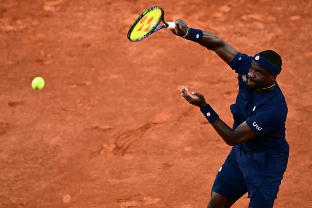 US Frances Tiafoe smashes the ball to Italy's Matteo Arnaldi during their men's singles match on day 9 of the French Open tennis tournament on Court Suzanne-Lenglen at the Roland-Garros Complex in Paris on June 1, 2026. (Photo by JULIEN DE ROSA / AFP)