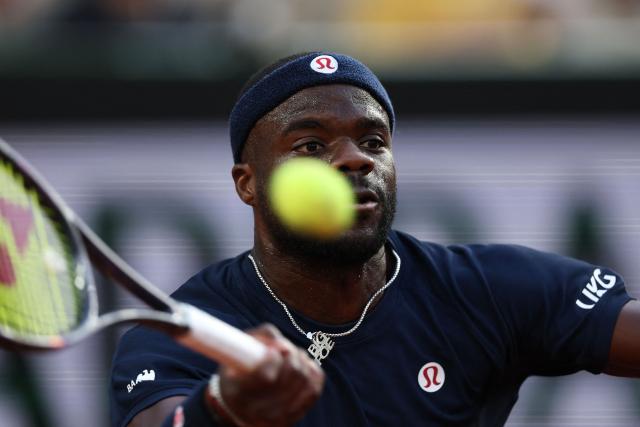 US Frances Tiafoe plays a forehand return to Italy's Matteo Arnaldi during their men's singles match on day 9 of the French Open tennis tournament on Court Suzanne-Lenglen at the Roland-Garros Complex in Paris on June 1, 2026. (Photo by Anne-Christine POUJOULAT / AFP)
