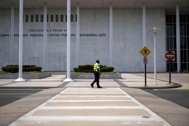A Security guard walk in front of The Donald J. Trump and John F. Kennedy Memorial Center for the Performing Arts in Washington, DC, on June 1, 2026. A US judge on May 29, 2026, ruled that the famed Kennedy Center for the Performing Arts had been illegally renamed after President Donald Trump and that his name must be taken down. (Photo by Kent Nishimura / AFP)