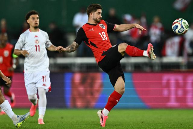 Austria's midfielder #18 Romano Schmid (R) plays the ball during the friendly football match between Austria and Tunisia in Vienna, Austria on June 1, 2026 ahead of the 2026 FIFA World Cup football tournament. (Photo by Joe Klamar / AFP)