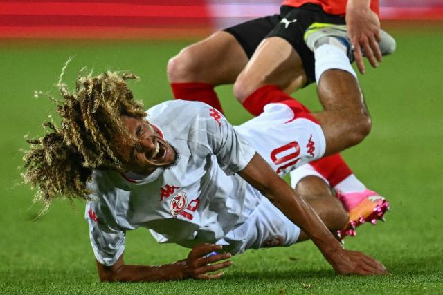 Tunisia's midfielder #10 Hannibal Mejbri is fouled by Austria's defender #15 Philipp Lienhart during the friendly football match between Austria and Tunisia in Vienna, Austria on June 1, 2026 ahead of the 2026 FIFA World Cup football tournament. (Photo by Joe Klamar / AFP)
