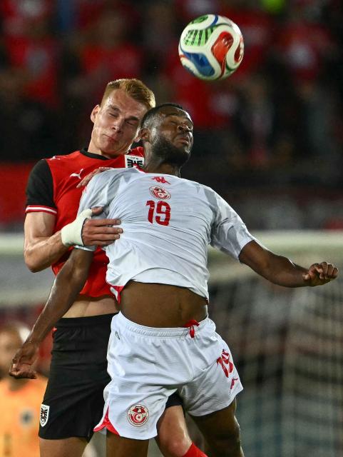 Tunisia's forward #19 Firas Chaouat (R) and Austria's defender #15 Philipp Lienhart both jump to head the ball during the friendly football match between Austria and Tunisia in Vienna, Austria on June 1, 2026 ahead of the 2026 FIFA World Cup football tournament. (Photo by Joe Klamar / AFP)