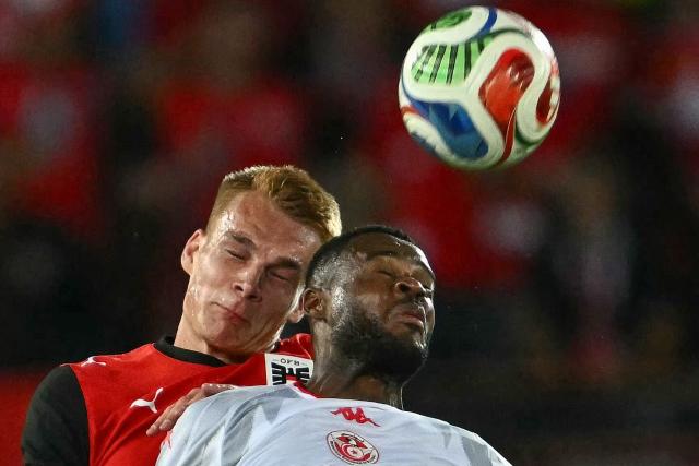 Tunisia's forward #19 Firas Chaouat (R) and Austria's defender #15 Philipp Lienhart both jump to head the ball during the friendly football match between Austria and Tunisia in Vienna, Austria on June 1, 2026 ahead of the 2026 FIFA World Cup football tournament. (Photo by Joe Klamar / AFP) / ALTERNATIVE CROP