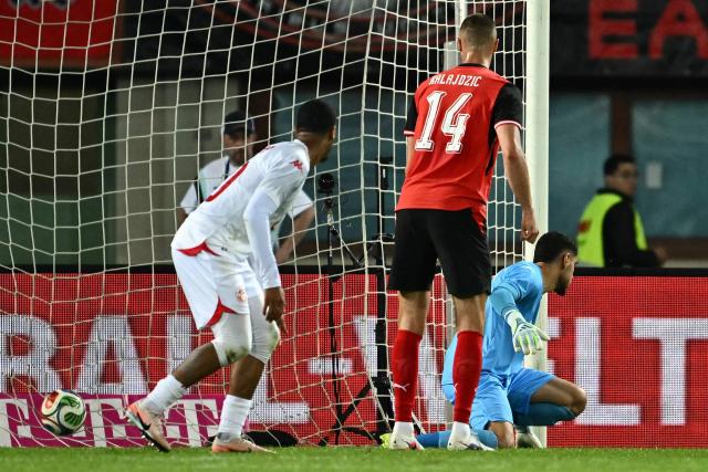 Tunisia's goalkeeper #01 Mouhib Chamakh (R) reacts after conciding the opening goal nex to Austria's forward #14 Sasa Kalajdzic (C) during the friendly football match between Austria and Tunisia in Vienna, Austria on June 1, 2026 ahead of the 2026 FIFA World Cup football tournament. (Photo by Joe Klamar / AFP)