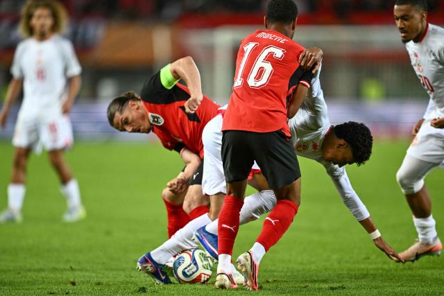 (front to back) Austria's defender #16 Philipp Mwene, Tunisia's midfielder #14 Khalil Ayari and Austria's forward #09 Marcel Sabitzer vie for the ball during the friendly football match between Austria and Tunisia in Vienna, Austria on June 1, 2026 ahead of the 2026 FIFA World Cup football tournament. (Photo by Joe Klamar / AFP)