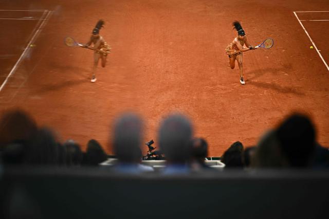 Japan's Naomi Osaka image is reflected in glass as she plays a backhand return to Aryna Sabalenka during their women's singles match on day 9 of the French Open tennis tournament on Court Philippe-Chatrier at the Roland-Garros Complex in Paris on June 1, 2026. (Photo by JULIEN DE ROSA / AFP)