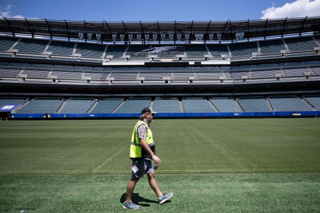 A worker walks along the pitch at Philadelphia Stadium (temporarily renamed from Lincoln Financial Field) ahead of the 2026 FIFA World Cup in Philadelphia, Pennsylvania, on June 1, 2026. (Photo by Brendan Smialowski / AFP)