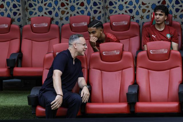 Morocco's head coach Mohamed Ouahbi chats with his players as he sits on the bench during of the friendly football match between Morocco and Madagascar at the Prince Moulay Abdellah Stadium in Rabat on June 2, 2026. (Photo by Abdel Majid BZIOUAT / AFP)