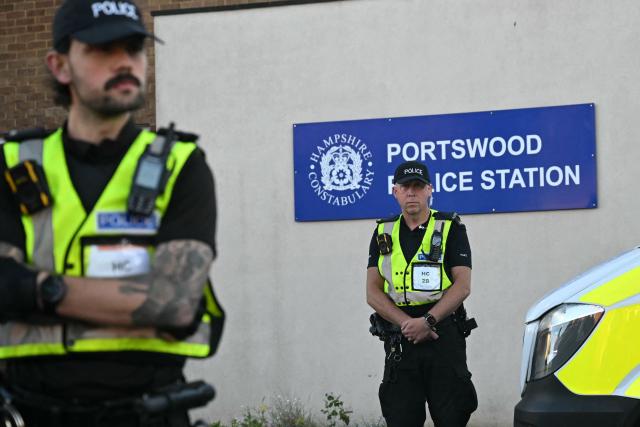 Police officers stand on duty outside Portswood Police station, following a protest march in Southampton, southern England, on June 2, 2026, held in reaction to the Police's handling of the detention of victim Henry Nowak, following the conviction of his murderer Vickrum Digwa. Body camera footage of dying student Henry Nowak, who was handcuffed by British police after being stabbed by Sikh man Vickrum Digwa, and falsely accused of racially abusing his murderer sparked outrage Tuesday. (Photo by JUSTIN TALLIS / AFP)