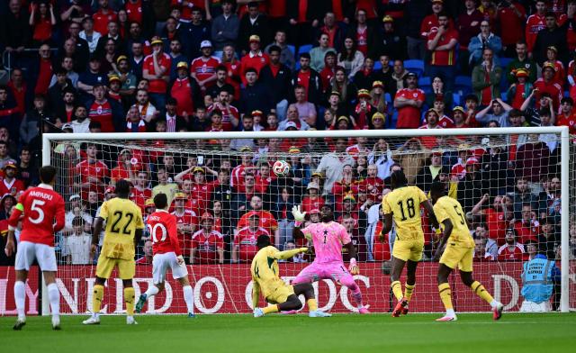 Ghana's goalkeeper #01 Lawrence Ati-Zigi saves a shot from Wales' midfielder #20 Daniel James during the international friendly football match between Wales and Ghana ahead of the 2026 FIFA World Cup football tournament, at Cardiff City Stadium, in Cardiff, on June 2, 2026. (Photo by Ben STANSALL / AFP)