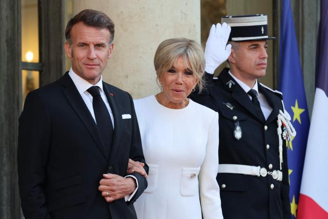 France's President Emmanuel Macron and his wife Brigitte Macron wait before welcoming Rwanda's President and his wife for a state dinner in their honor at the Elysee Presidential Palace, in Paris on June 2, 2026. France's president hailed France's "unprecedented" rapprochement with Rwanda as he unveiled a monument to victims of the 1994 genocide in the presence of the leader of the east African nation. (Photo by Ludovic MARIN / AFP)