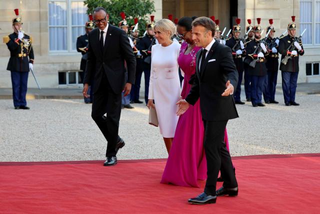 France's President Emmanuel Macron and his wife Brigitte Macron (L) welcome Rwanda's President Paul Kagame and his wife Jeannette Kagame upon their arrival for a state dinner in their honor at the Elysee Presidential Palace, in Paris on June 2, 2026. France's president hailed France's "unprecedented" rapprochement with Rwanda as he unveiled a monument to victims of the 1994 genocide in the presence of the leader of the east African nation. (Photo by Ludovic MARIN / AFP)