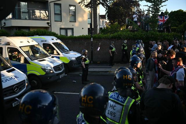 Demonstrators throw items at Police offices and vans outside Portswood Police station, following a protest march in Southampton, southern England, on June 2, 2026, held in reaction to the Police's handling of the detention of victim Henry Nowak, following the conviction of his murderer Vickrum Digwa. Body camera footage of dying student Henry Nowak, who was handcuffed by British police after being stabbed by Sikh man Vickrum Digwa, and falsely accused of racially abusing his murderer sparked outrage Tuesday. (Photo by JUSTIN TALLIS / AFP)