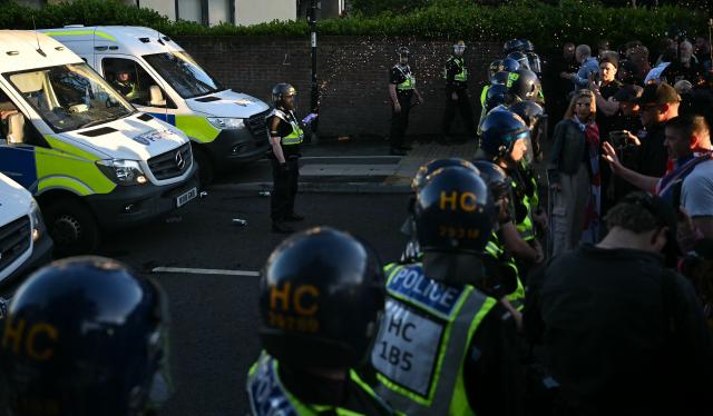 Demonstrators throw items at Police offices and vans outside Portswood Police station, following a protest march in Southampton, southern England, on June 2, 2026, held in reaction to the Police's handling of the detention of victim Henry Nowak, following the conviction of his murderer Vickrum Digwa. Body camera footage of dying student Henry Nowak, who was handcuffed by British police after being stabbed by Sikh man Vickrum Digwa, and falsely accused of racially abusing his murderer sparked outrage Tuesday. (Photo by JUSTIN TALLIS / AFP)
