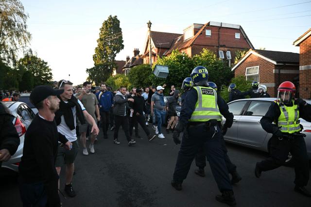 Demonstrators throw objects at Police officers near Portswood Police station, following a protest march in Southampton, southern England, on June 2, 2026, held in reaction to the Police's handling of the detention of victim Henry Nowak, following the conviction of his murderer Vickrum Digwa. Body camera footage of dying student Henry Nowak, who was handcuffed by British police after being stabbed by Sikh man Vickrum Digwa, and falsely accused of racially abusing his murderer sparked outrage Tuesday. (Photo by JUSTIN TALLIS / AFP)