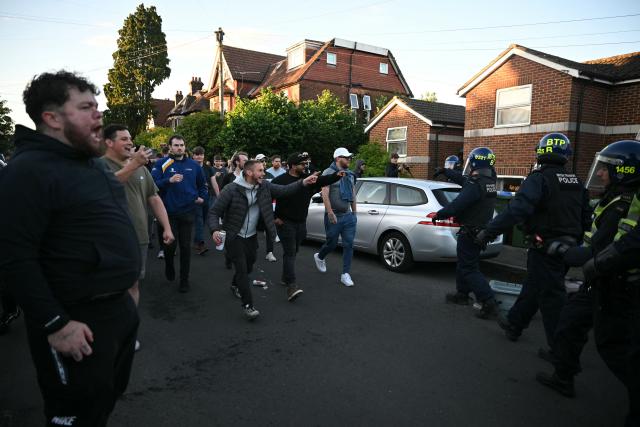 Police officers are attacked by demonstrators near Portswood Police Station, following a protest march in Southampton, southern England, on June 2, 2026, held in reaction to the Police's handling of the detention of victim Henry Nowak, following the conviction of his murderer Vickrum Digwa. Body camera footage of dying student Henry Nowak, who was handcuffed by British police after being stabbed by Sikh man Vickrum Digwa, and falsely accused of racially abusing his murderer sparked outrage Tuesday. (Photo by JUSTIN TALLIS / AFP)