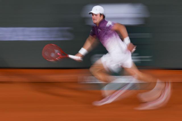 Brazil's Joao Fonseca runs for the tennis ball as he plays against Czech Republic's Jakub Mensik during their men's quarter final singles match on day 10 of the French Open tennis tournament on Court Philippe-Chatrier at the Roland-Garros Complex in Paris on June 2, 2026. (Photo by Anne-Christine POUJOULAT / AFP)