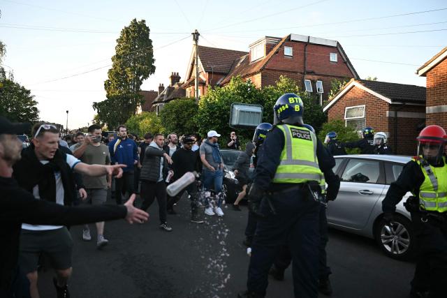 Police officers are attacked by demonstrators near Portswood Police Station, following a protest march in Southampton, southern England, on June 2, 2026, held in reaction to the Police's handling of the detention of victim Henry Nowak, following the conviction of his murderer Vickrum Digwa. Body camera footage of dying student Henry Nowak, who was handcuffed by British police after being stabbed by Sikh man Vickrum Digwa, and falsely accused of racially abusing his murderer sparked outrage Tuesday. (Photo by JUSTIN TALLIS / AFP)