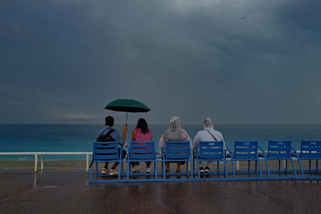 People look at the Mediterranean sea on the "Promenade des anglais" on the French riviera city of Nice, on June 2, 2026. (Photo by Valery HACHE / AFP)