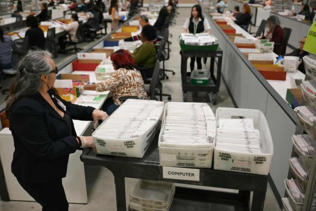 An election worker moves mail-in ballots to be organized for tabulation at the Los Angeles County Ballot Processing Center during California's state primary election in the City of Industry, California, on June 2, 2026. Californians go to the polls June 2 in the first round of voting for a new governor, with a tight three-way race for two run-off spots, while people in Los Angeles will also be voting for a new mayor. The state's so-called "jungle primary" pits all comers against each other -- regardless of party -- with the top two vote-getters advancing to the November general election to replace term-limited Governor Gavin Newsom. (Photo by Patrick T. Fallon / AFP)