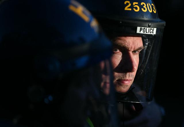 Police officers hold their line near Portswood Police Station in Southampton, southern England, on June 2, 2026, during a protest held in reaction to the Police's handling of the detention of victim Henry Nowak, following the conviction of his murderer Vickrum Digwa. Body camera footage of dying student Henry Nowak, who was handcuffed by British police after being stabbed by Sikh man Vickrum Digwa, and falsely accused of racially abusing his murderer sparked outrage Tuesday. (Photo by JUSTIN TALLIS / AFP)