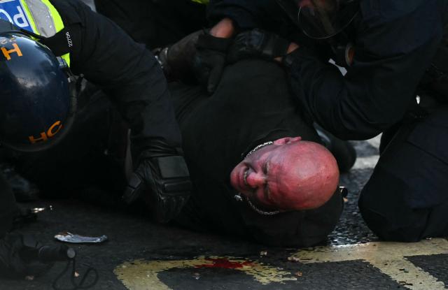 Police officers detain a protestor near Portswood Police Station in Southampton, southern England, on June 2, 2026, during a protest held in reaction to the Police's handling of the detention of victim Henry Nowak, following the conviction of his murderer Vickrum Digwa. Body camera footage of dying student Henry Nowak, who was handcuffed by British police after being stabbed by Sikh man Vickrum Digwa, and falsely accused of racially abusing his murderer sparked outrage Tuesday. (Photo by JUSTIN TALLIS / AFP)
