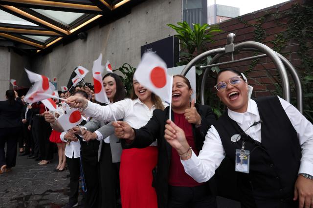 Mexican hotel workers wave Japanese flags to welcome Japan's players in Monterrey, Mexico on June 2, 2026, ahead of the FIFA 2026 World Cup football tournament. (Photo by Julio Cesar AGUILAR / AFP)