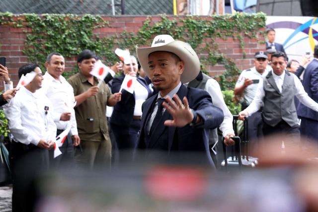Japan's defender Yuto Nagatomo waves as he arrives at the Live Aqua hotel in Monterrey, Mexico on June 2, 2026, ahead of the FIFA 2026 World Cup football tournament. (Photo by Julio Cesar AGUILAR / AFP)