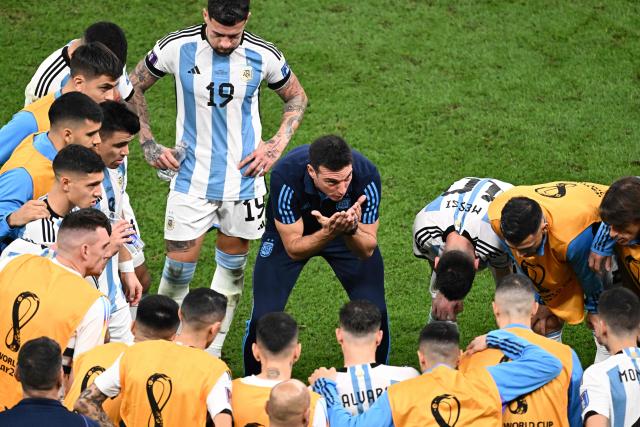 (FILES) Argentina's coach #00 Lionel Scaloni talks to his players before extra time during the Qatar 2022 World Cup final football match between Argentina and France at Lusail Stadium in Lusail, north of Doha on December 18, 2022. Players from Argentina’s 2022 World Cup–winning national team recalled in a documentary miniseries the moments leading up to the final against France, when coach Lionel Scaloni couldn’t hold back his tears of emotion: “It was the worst tactical talk in the world,” one of his assistants remembered, laughing. (Photo by Jewel SAMAD / AFP)