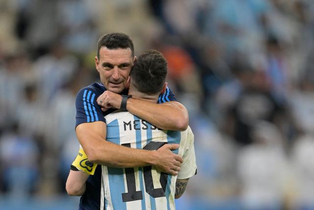 (FILES) Argentina's forward #10 Lionel Messi is embraced by Argentina's coach #00 Lionel Scaloni after their team's victory in the Qatar 2022 World Cup quarter-final football match between The Netherlands and Argentina at Lusail Stadium, north of Doha on December 9, 2022. Players from Argentina’s 2022 World Cup–winning national team recalled in a documentary miniseries the moments leading up to the final against France, when coach Lionel Scaloni couldn’t hold back his tears of emotion: “It was the worst tactical talk in the world,” one of his assistants remembered, laughing. (Photo by JUAN MABROMATA / AFP)