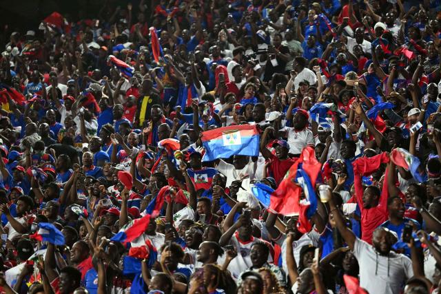 Haiti's football fans celebrate after their team scored a goal during an international friendly football match between Haiti and New Zealand at Chase Stadium in Fort Lauderdale, Florida, on June 2, 2026. (Photo by CHANDAN KHANNA / AFP)