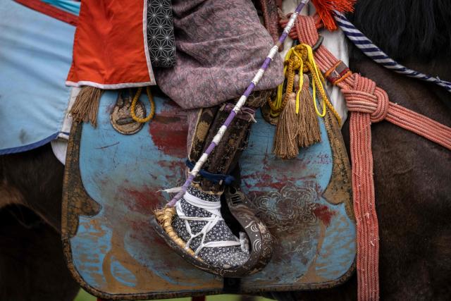 Ancient armor worn by a samurai horseman is seen during the Soma Nomaoi festival at Hibarigahara field in Minamisoma, Fukushima prefecture on May 24, 2026. The Soma Nomaoi began as a way to train mounted warriors and it still looks the same a millennium later, with riders dressed in samurai armour battling it out in horseback events. (Photo by Yuichi YAMAZAKI / AFP) / To go with 'Japan-Climate-Festival-Tradition' Focus by Andrew MCKIRDY