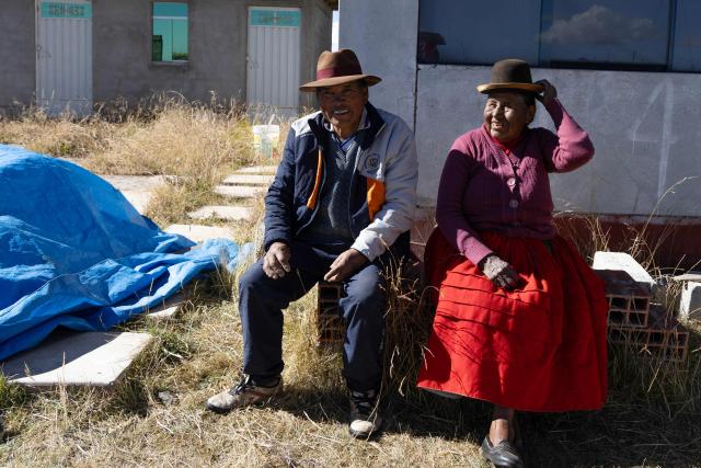Rufino Cutipa (L) and his wife Dominga Quenta (R) sit outside their home in the community of Caritamaya, near Lake Titicaca, Puno region, Peru, on May 29, 2026. Days before the presidential runoff between right-wing candidate Keiko Fujimori and left-wing candidate Roberto Sanchez, farmers in Peru's Altiplano no longer believe in politicians' promises. (Photo by Juan Carlos CISNEROS / AFP)