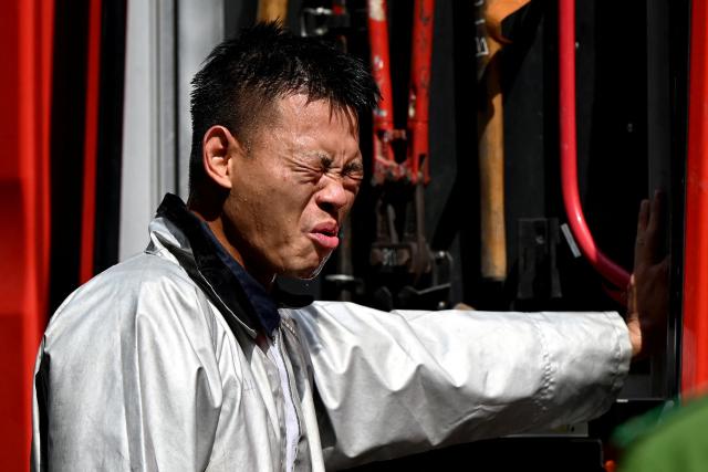 A man grimaces in the heat in Hanoi on June 3, 2026. (Photo by Nhac NGUYEN / AFP)