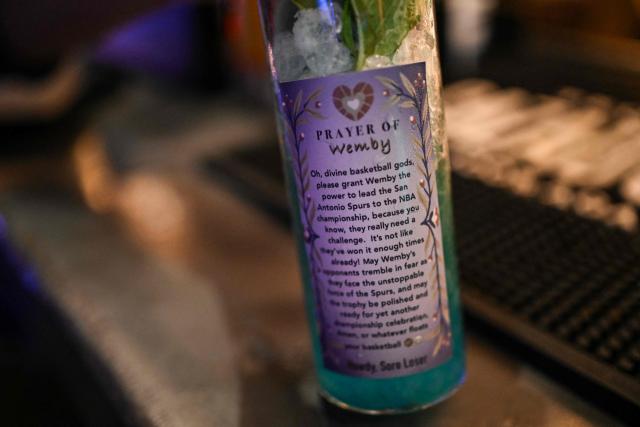 The “Prayer of Wemby” is seen in a glass featuring an image of San Antonio Spurs French basketball player Victor Wembanyama, at a bar in downtown San Antonio, Texas, on June 2, 2026. The Spurs will face the New York Knicks in the NBA Finals, which begin on June 3. (Photo by RONALDO SCHEMIDT / AFP)